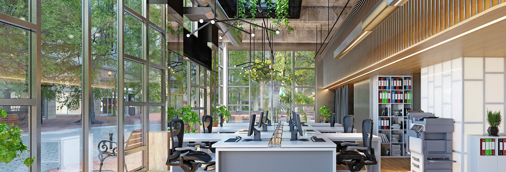 Das Bild zeigt ein modernes Großraumbüro mit viel Glas und Grün:
Große Fensterfronten bringen Tageslicht rein, vermutlich energetisch optimiert.
Die Einrichtung ist offen, minimalistisch und auf Effizienz getrimmt: Schreibtischreihen mit Monitoren, ergonomische Bürostühle, Meeting-Zone im Hintergrund.
Viele Pflanzen (auch von der Decke hängend) schaffen ein angenehmes Raumklima – Biophilic Design lässt grüßen.
Rechts ein Drucker-/Kopierbereich und ein Regal mit Aktenordnern – Papier ist also noch nicht ganz tot.
Fazit: Wenn schon Büro, dann so. Fehlt nur noch der Kaffeevollautomat und ein Chef, der nicht nervt.